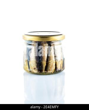 Isolate of a glass jar with sprats. Fish in a glass jar. Front view. Stock Photo