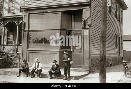 This is a Bar in Parsons Pennsylvania USA with an Anthracite Coal Miner and three other men out front. 100 George Ave. Parsons, Wilkes Barre PA. Late 1800s or very early 1900s Stock Photo