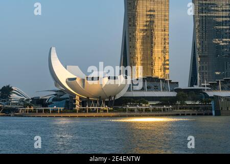 Facade of the Art Science Museum in the shape of a Lotus flower in Singapore under evening light. Background is the Marina Bay Sands Hotel. Stock Photo