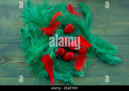 Macro photo of red easter quail egg. Painted red quail eggs on a green wood background. Easter Stock Photo