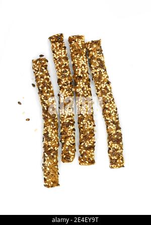 Stick crackers. Sesame- linen stick crackers. Pretzel bread stick with sesame and linen, flax seeds isolated on white background. Stock Photo