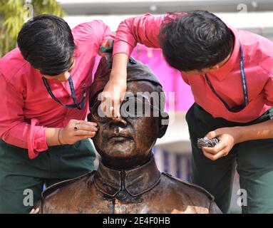 The school students of Netaji Subhas Vidyaniketan washed and cleaned the statue of Netaji Subhash on the eve of the birth anniversary of Indian nationalist, Netaji Subhas Chandra Bose. Netaji Subash Chandra Bose's birthday on January 23rd will be celebrated as Parakarm Diwas. Bose was a prominent Indian nationalist leader who attempted to gain India's independence from British rule by force during the waning years of World War II. Agartala, Tripura, India. Stock Photo