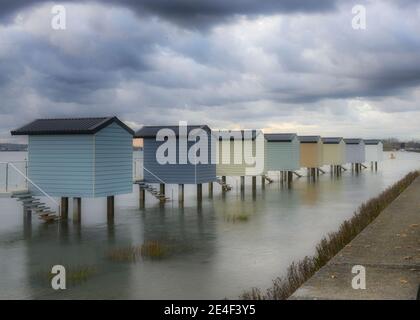 Beach Huts at Osea, Essex at low tide Stock Photo