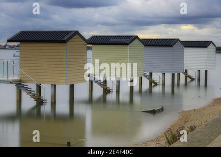Beach Huts at Osea, Essex at low tide Stock Photo