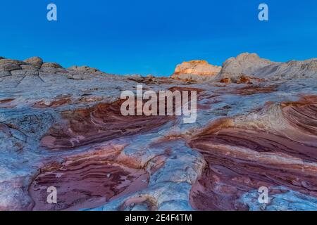 First light on the Navajo Sandstone formations of White Pocket, Vermilion Cliffs National Monument, Arizona, USA Stock Photo