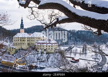 Aerial view of the Weesenstein castle in winter, houses of the village covered with snow. Stock Photo
