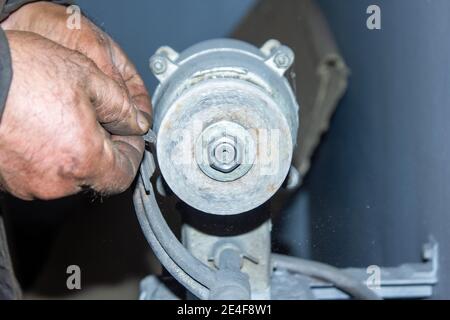 person working with electrical grinder in factory Stock Photo