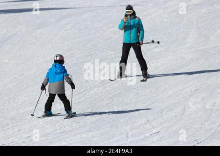 Gusar - Azerbaijan: January 2019. Little boy learning skiing with his father during winter holidays in Shahdag Mountain Resort Stock Photo