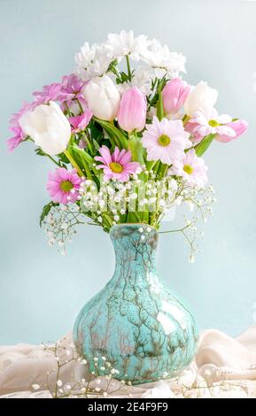 vertical image of spring flowers in a pretty vase  for mothers day , easter or valentines.room for copy space and text overlay Stock Photo