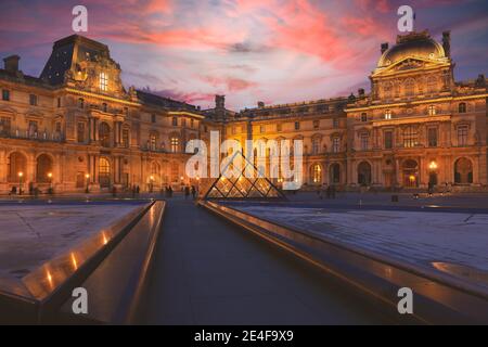 Paris - December 26, 2018 : View of Louvre building at courtyard in the evening. Louvre Museum is one of the largest and most visited museums worldwid Stock Photo