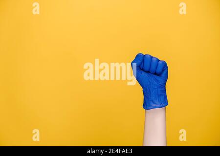 Hand gesture and coronavirus concept. Close up of female hand in medical protection blue gloves knock knock knocking on camera Stock Photo
