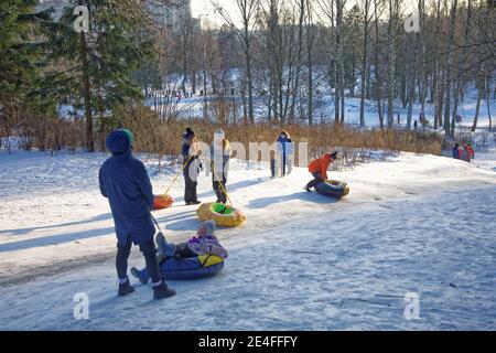 Russia. St. Petersburg. January 09.2021. Shuvalov park.Sledding from a high mountain.Both adults and children love to sled fast.People love extreme de Stock Photo