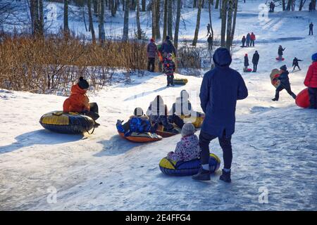 Russia. St. Petersburg. January 09.2021. Shuvalov park.Sledding from a high mountain.Both adults and children love to sled fast.People love extreme de Stock Photo