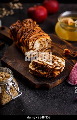 Swirl brioche or traditional Polish babka cake with walnut, apple and honey Stock Photo