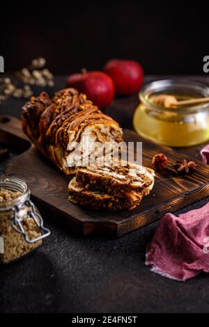 Swirl brioche or traditional Polish babka cake with walnut, apple and honey Stock Photo