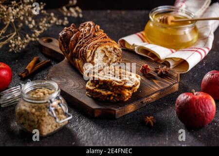 Swirl brioche or traditional Polish babka cake with walnut, apple and honey Stock Photo