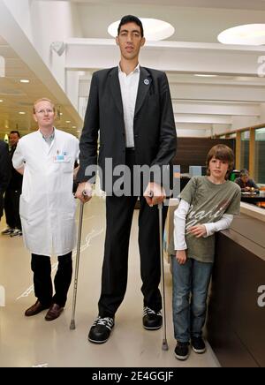 EXCLUSIVE. Turk Sultan Kosen, who is the current record holder of the tallest living man in the world as recognised by Guinness World Records, poses with Dutch endocrinologist Wouter de Herder, Chairman The European Neuroendocrine Tumor Society (ENETS) in the entrance hall of Erasmus MC hospital in Rotterdam, The Netherlands on November 9, 2009. Sultan is in Holland as part of a world tour to promote the Guinness Book of Records 2010. Born on September 27, 1982 in eastern Turkey, Sultan is 2,46m tall et has shoe size 60. Due to his extreme size he never worked. Photo by Alain Gil Gonzales/ABAC Stock Photo