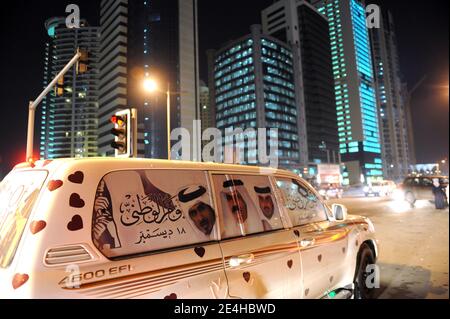 Qatari people decorate their 4-wheel-drive cars with hearts, flags, portraits of the Emir, and dance on the car's rooftop as they celebrate Qatar's National Day, in Doha, Qatar on December 18, 2009. Photo by Ammar Abd Rabbo/ABACAPRESS.COM Stock Photo