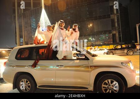 Qatari people decorate their 4-wheel-drive cars with hearts, flags, portraits of the Emir, and dance on the car's rooftop as they celebrate Qatar's National Day, in Doha, Qatar on December 18, 2009. Photo by Ammar Abd Rabbo/ABACAPRESS.COM Stock Photo