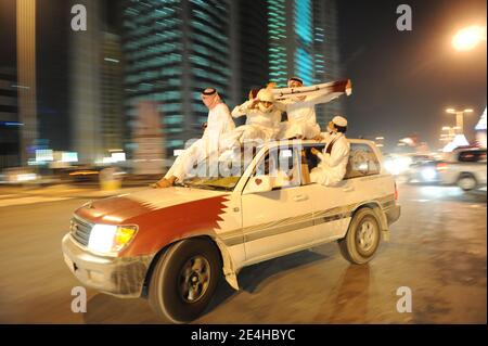 Qatari people decorate their 4-wheel-drive cars with hearts, flags, portraits of the Emir, and dance on the car's rooftop as they celebrate Qatar's National Day, in Doha, Qatar on December 18, 2009. Photo by Ammar Abd Rabbo/ABACAPRESS.COM Stock Photo