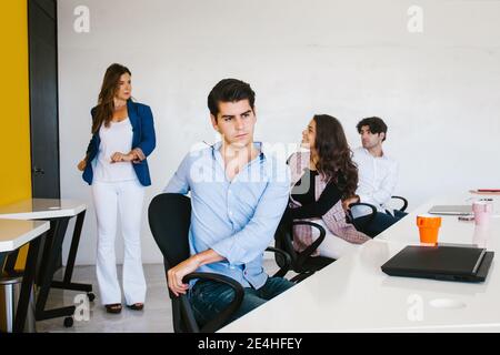 latin business people meditating and doing yoga in office in Mexico city Stock Photo