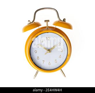 Hand of hispanic man holding yellow alarm clock over isolated white background. Stock Photo