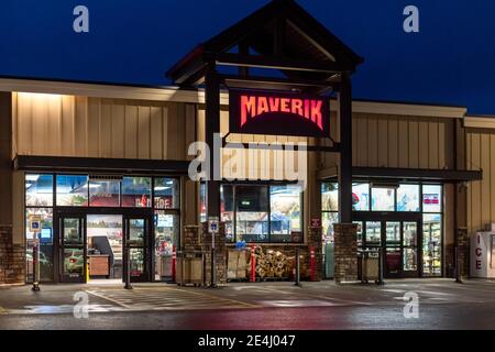 Night view of the illuminated sign on a Maverik gasoline station and convenience store in Post Falls, Idaho, USA. Stock Photo