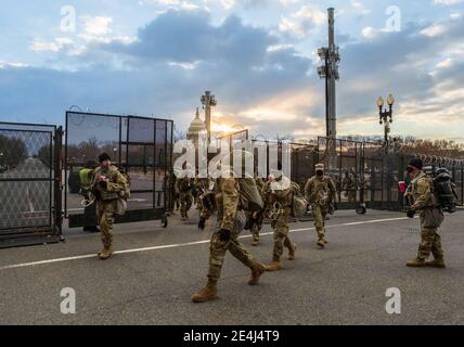 Washington, United States. 23rd Jan, 2021. Members of the National Guard unit leave the grounds of the United States Capitol building at sunrise a few days after the inauguration of President Joe Biden and Vice President Kamala Harris. The Capitol was breached during an insurrection January 6 just days before the inauguration. Credit: SOPA Images Limited/Alamy Live News Stock Photo