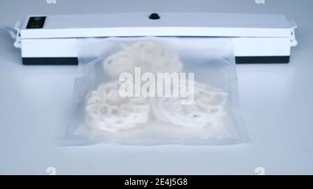 Wrap food using a vacuum sealer machine. Stock Photo