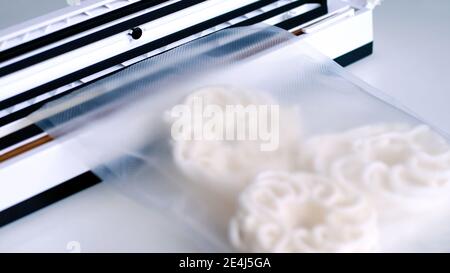 Wrap food using a vacuum sealer machine. Stock Photo