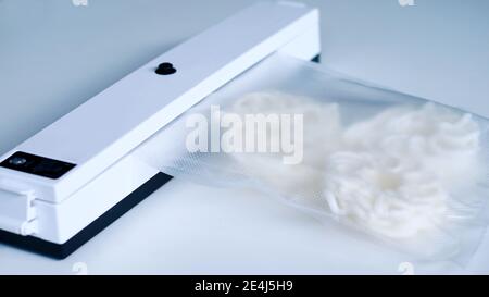 Wrap food using a vacuum sealer machine. Stock Photo