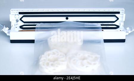 Wrap food using a vacuum sealer machine. Stock Photo