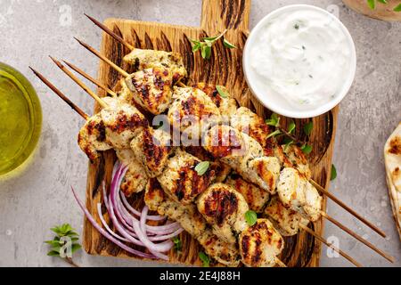 Greek chicken souvlaki on wooden skewers Stock Photo