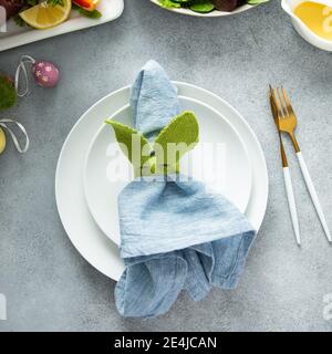 Easter brunch table setting with a napkin on a plate Stock Photo