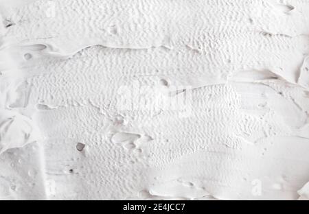 rough, dense strokes of thick paint. White abstract texture of surface with volume relief structure of putty Stock Photo