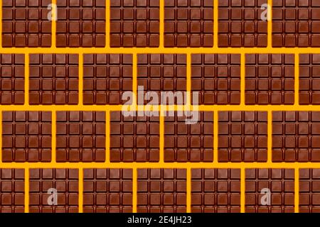 Pattern of chocolate bars against yellow background Stock Photo