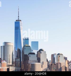 USA, New York, New York City, Lower Manhattan buildings with One World Trade Center against clear sky Stock Photo