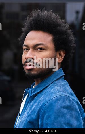 Close-up portrait of serious stylish man with afro hair Stock Photo