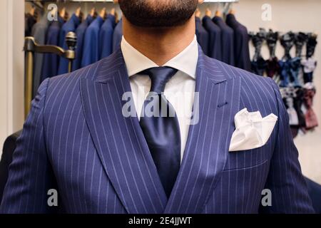 Man in blue pinstripe suit in tailors boutique Stock Photo