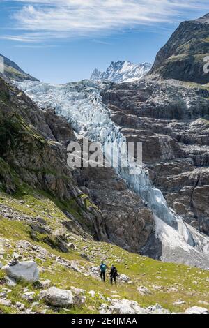 Hikers on the hiking trail to the Schreckhornhuette, high alpine mountain landscape, Lower Arctic Ocean, glacier tongue, Bernese Oberland, Switzerland Stock Photo
