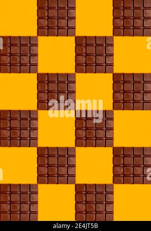 Pattern of chocolate bars against yellow background Stock Photo