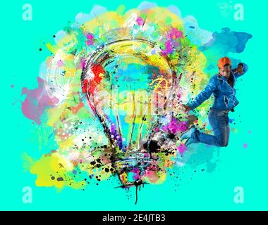 Man draws with spray a big stylized light bulb on cyan background. Concept of innovation and creativity Stock Photo