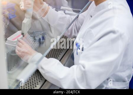Female scientist researching about coronavirus in laboratory Stock Photo