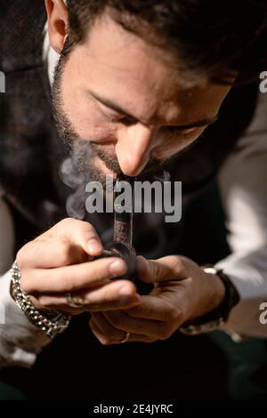 Bearded man smoking pipe Stock Photo