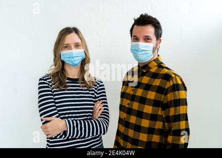 Studio portrait of woman and man wearing face masks Stock Photo