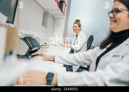 Smiling female pharmacists working in chemist store Stock Photo