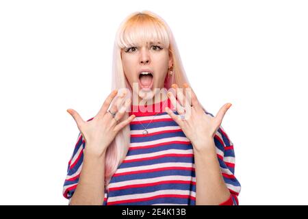 Shocked young woman gesturing against white background Stock Photo