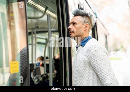 Stylish male entrepreneur commuting in train Stock Photo