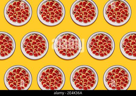 Pattern of plates with fresh halved figs Stock Photo