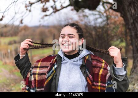 Braided smiling teenage girl in Autumn landscape Stock Photo